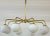 Mid-century modern lines in antique brass finished metal suspend eight glowing orbs in this retro-futurist take on a...