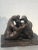 Bronze sculpture depicting a family in the manner/style of Henry Moore (BRITISH, 1898-1986). Mounted on a lucite base. Un-...