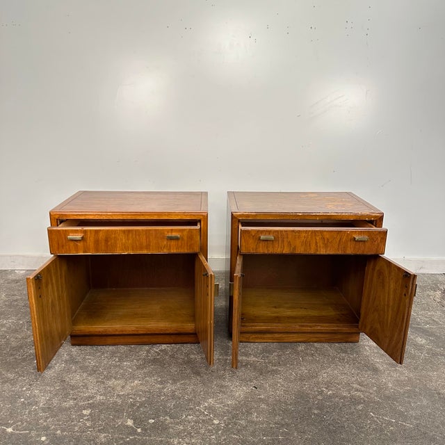 Pair of Drexel Heritage Consensus Pecan Nightstands These Campaign style nightstands were made in the 1970s with a pecan...