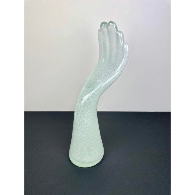 Big elegant sculpture in Murano glass in the shape of a human hand by the Italian artist Vistosi. His signature is...