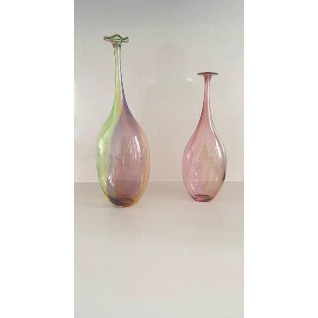 Pair of warm colored bottles with rounded shapes and long, proud necks. Great skills are required on the part of the...