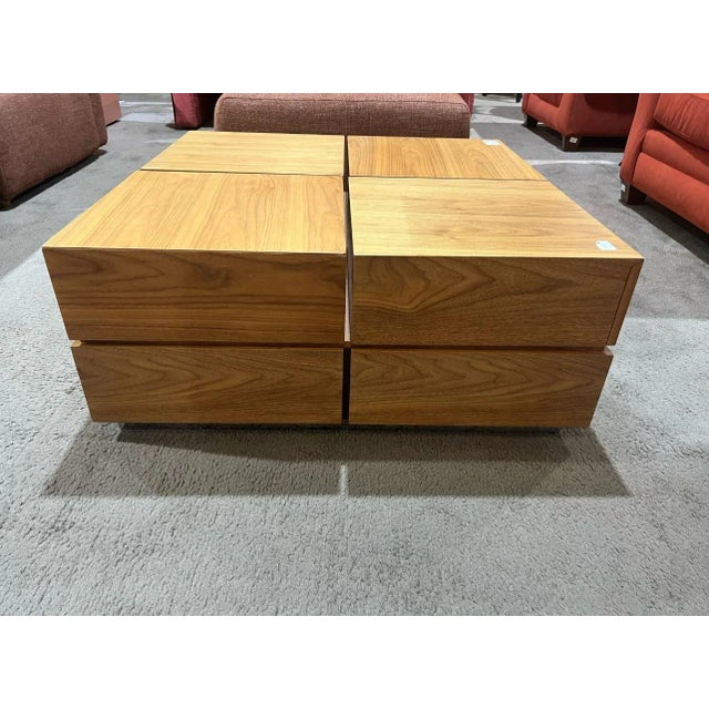 Clean lines and clever design come together in this contemporary square wood coffee table. Crafted with a warm natural...