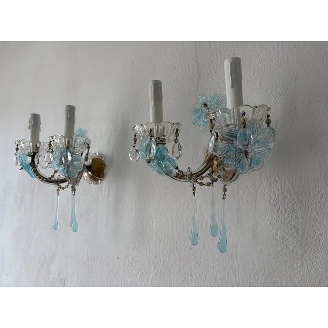 Beautiful one of a kind rare set of sconces housing two lights each, sitting in crystal bobeches dripping with vintage...