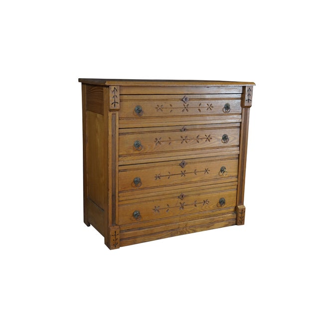 This four-drawer Victorian era chest is crafted from oak and ash wood, which is highly visible through the prominent,...