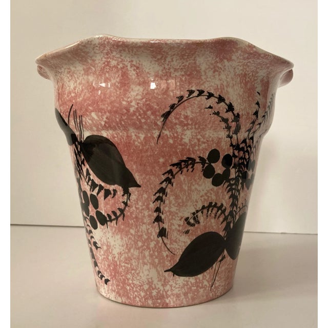 Hand painted black flora design on pink speckled ivory ground. Designed with a ruffle top finished with a high gloss...