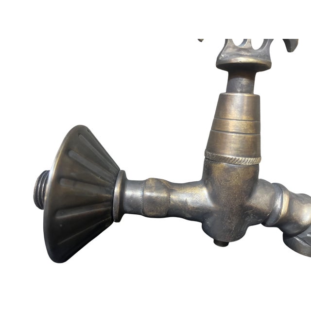 Water flows differently when it comes from a piece of history. This is not a standard plumbing fixture; it is a solid cast...