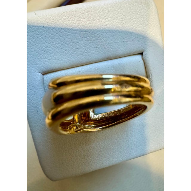 VAN CLEEF & ARPELS Created by Van Cleef & Arpels, this “Twisted” ring is composed of two pieces of Mother of pearl....