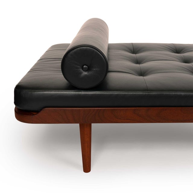 This stunning vintage Danish mid-century modern teak daybed has been expertly reupholstered in luxurious black leather by...