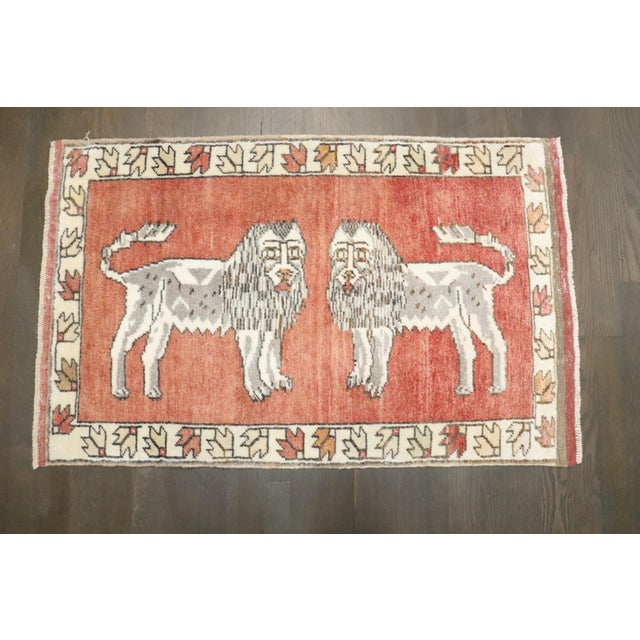 A pair of mid-20th century turkish rugs depicting multiple lions