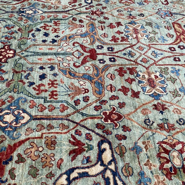 Persian Farahan design hand-knotted rug featuring a luminous sage green field woven with an all-over interlocking trellis...
