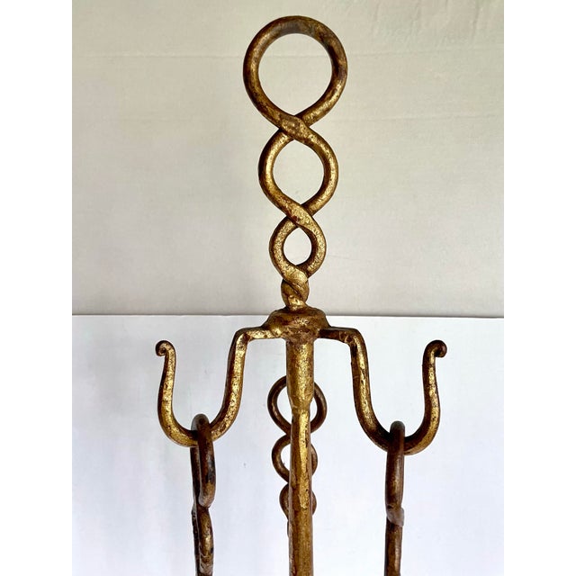 Here is a beautiful vintage gilt iron fireplace tool set dating to approximately the 1960s. Both decorative and...