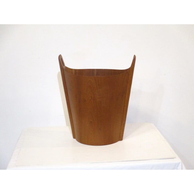 A very well crafted hand formed teak wood waste basket or magazine holder with sculptural handles to each side . Retains...