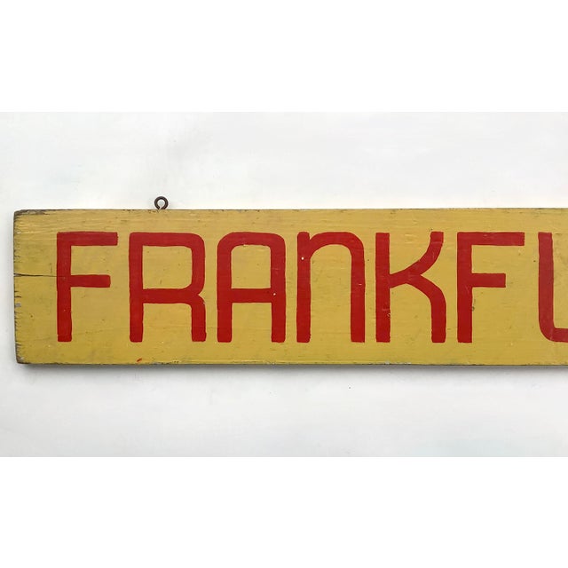 Circa 1940s hand lettered yellow and red wood Frankfurts sign with original hooks for hanging. Sign has cracks, paint...