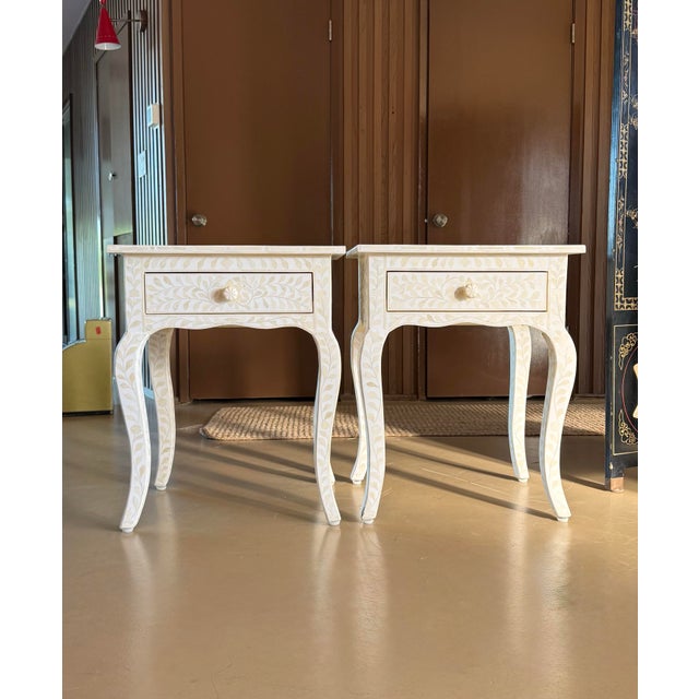 A pair of « Amira » mosaic inlaid side tables / night stands by Restoration Hardware, 21st century. These pieces are no...