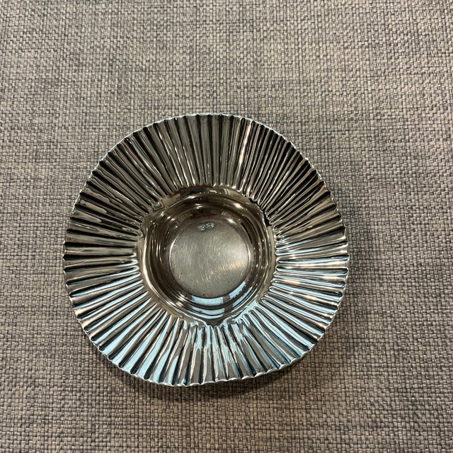 Beautifully designed bowl with wavy sides that reflect the light. Sterling silver and polishes beautifully. Maker is unknown.