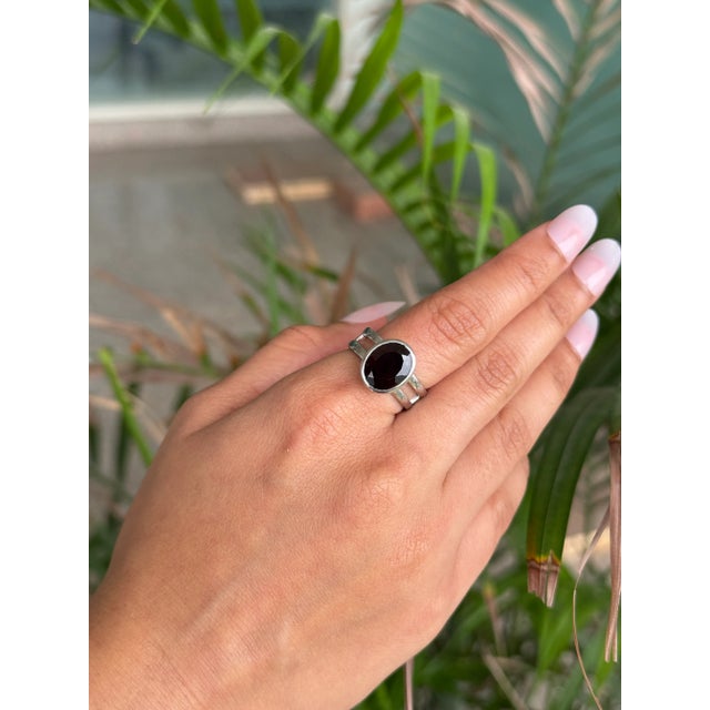 This elegant Garnet Solitaire Ring is beautifully crafted in 925 Sterling Silver with a modern double-row band design. The...