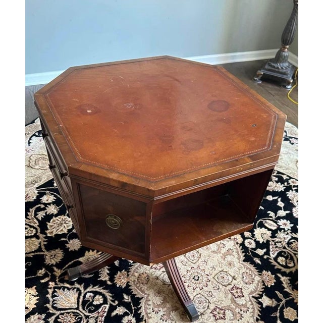 Has 4 drawers and 2 open spaces, 4 side panels do not open. Original hardware. Beautiful fluted legs with metal caps....