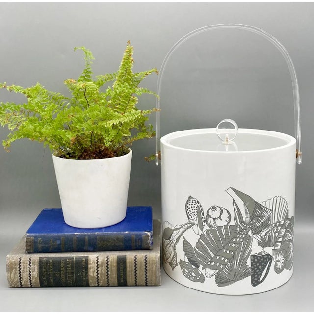 Delightful, nautical themed ice bucket from the mid-late 20th century. Stunning gray seashell design embellishes the white...