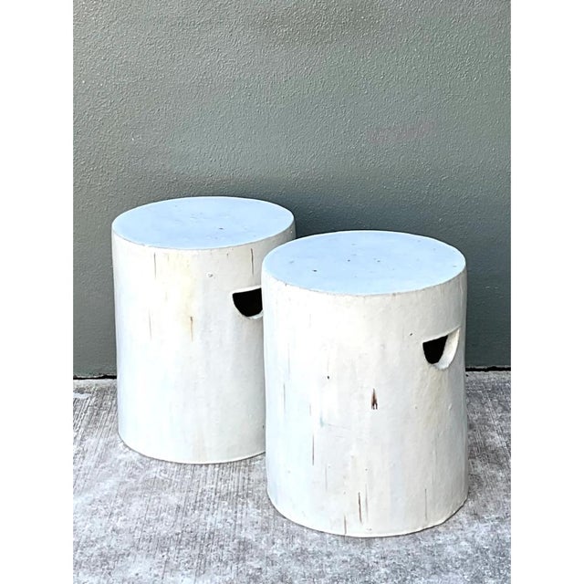 This vintage pair of white ceramic low stools offers a quietly sculptural presence, each cylindrical form rising straight...