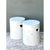 This vintage pair of white ceramic low stools offers a quietly sculptural presence, each cylindrical form rising straight...