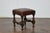 An English oak footstool from the 19th century with leather seat and turned legs. This English oak stool from the 19th...