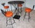 Spanish Revival Vintage Spanish Revival Wrought Iron Swivel Bar Stool Set With Matching Mesh Bar Table & Heavy Umbrella Stand – Mid-Century, Orange Vinyl For Sale - Image 3 of 12