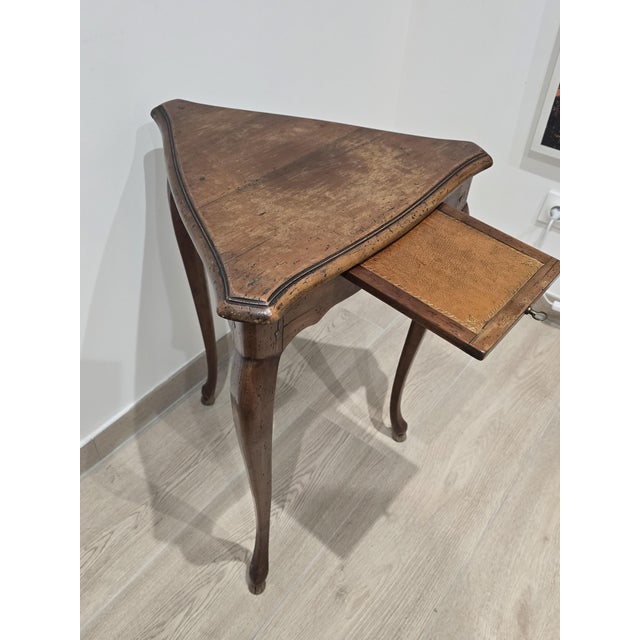 An elegant and original triangular tripod side table made in the early 20th century by the prestigious cabinetmaking firm...