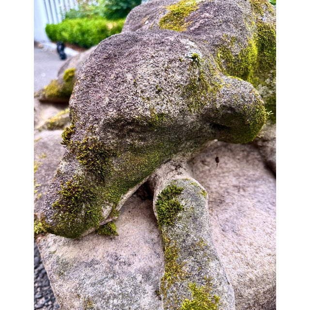 A wonderfully weathered recumbent garden hound figure with richly developed moss, soft sculptural lines, and the romantic...