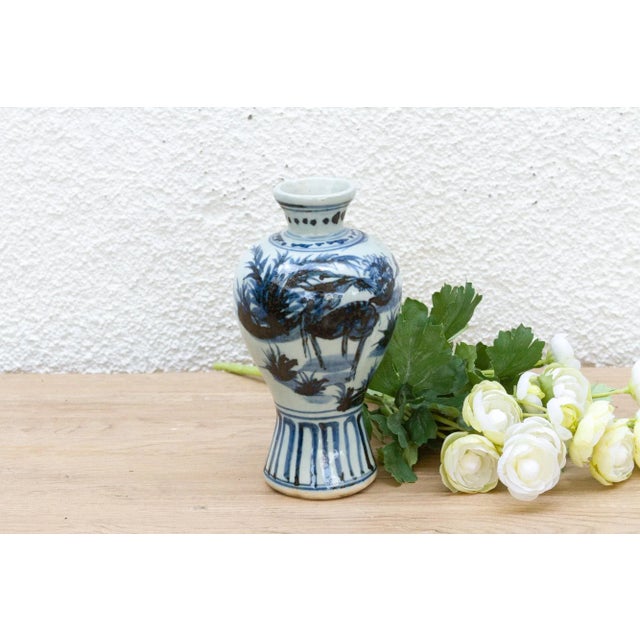 This small vase is a masterpiece of serene beauty. This antique Chinese porcelain vase, likely dating to the early 20th...