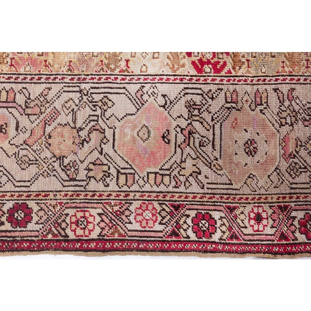 This exquisite antique Turkish Ghiordes rug measures approximately 14 x 12 feet, showcasing a remarkable blend of...