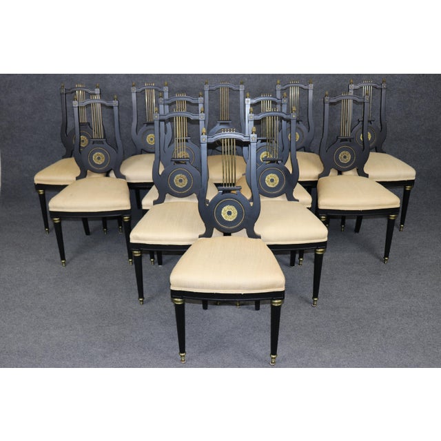 Refine your dining experience with this exceptional Maison Jansen set of 12 dining chairs, a rare and highly collectible...
