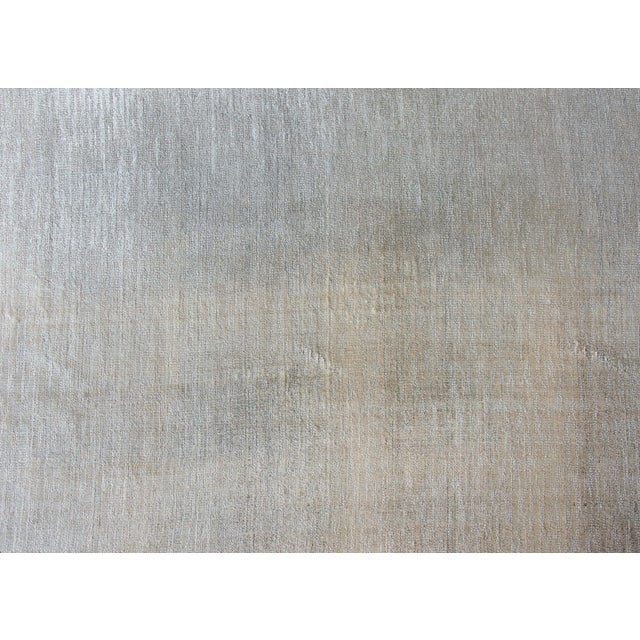 A stunning and chic late 20th century Indian Gabbeh-style hand knotted silver silk rug woven with a cut and loop pattern...