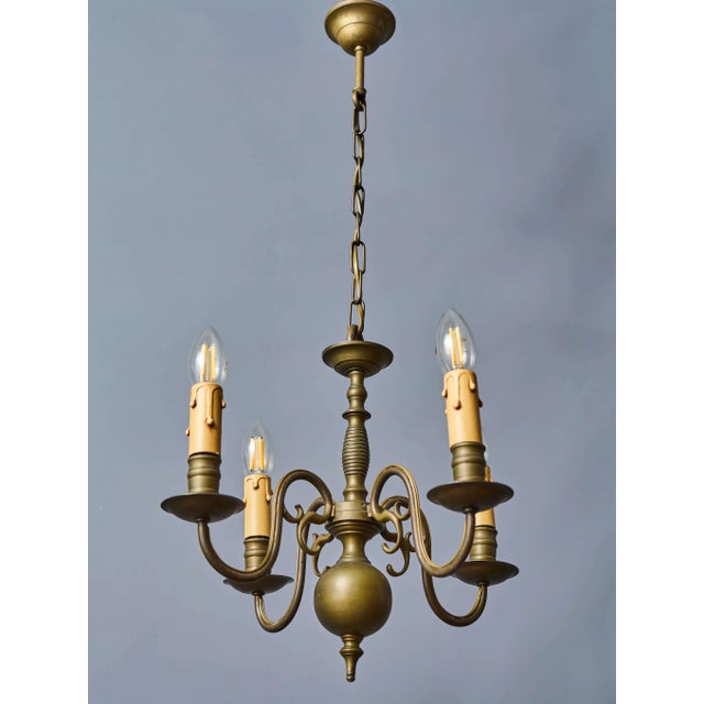An elegant smaller antique bronze chandelier from flanders, dating back to around the mid-19th century. The chandelier is...
