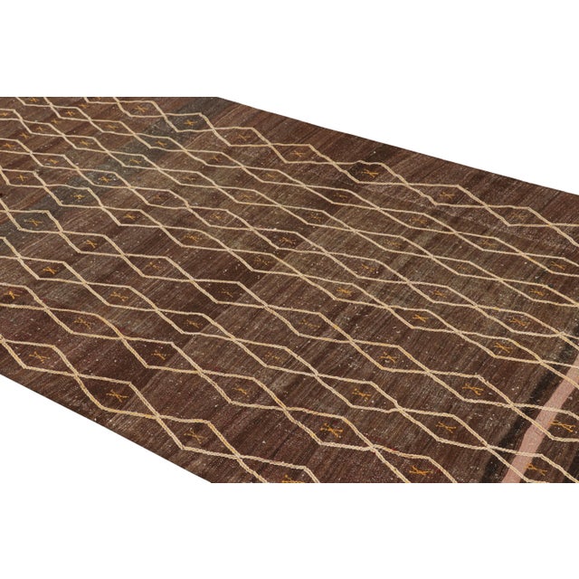 Handwoven in wool and originating from Morocco circa 1950-1960, this 5x10 vintage Moroccan Kilim rug is a rich new...