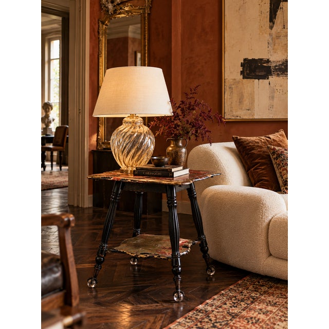 Antique late 19th century parlor table with a shaped square top, lower shelf, fluted turned legs and distinctive metal...