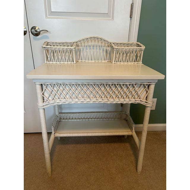 Exceptionally well-preserved wicker desk and chair set from early 20th century with classic diamond lattice panels. It was...