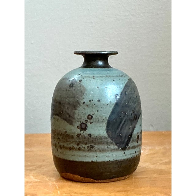 This vintage abstract stoneware vase exemplifies the expressive character of mid-century studio pottery through its...