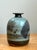 This vintage abstract stoneware vase exemplifies the expressive character of mid-century studio pottery through its...