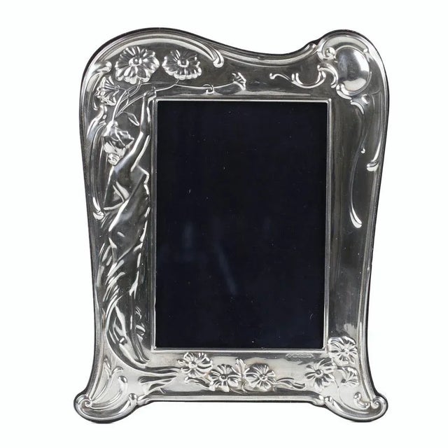 An elegant tabletop photograph frame in Art Nouveau style, crafted in sterling silver (925) with exquisite repoussé...