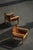 A pair of charming Swedish Mid Century Modern lounge chairs in solid pine, upholstered in leather with a fine patina....