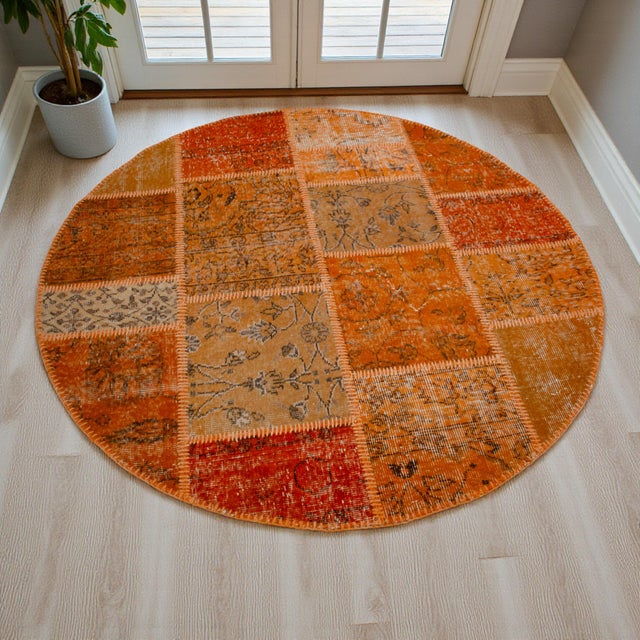 This sophisticated circular patchwork rug is a masterclass in the art of repurposing, bringing together hand-knotted...