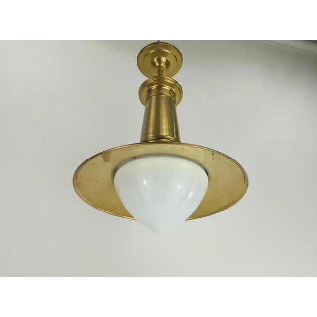 Solid brass industrial hing lamp with opal screen. Savings arch lamp around 1910 was revised by the architect and artist...