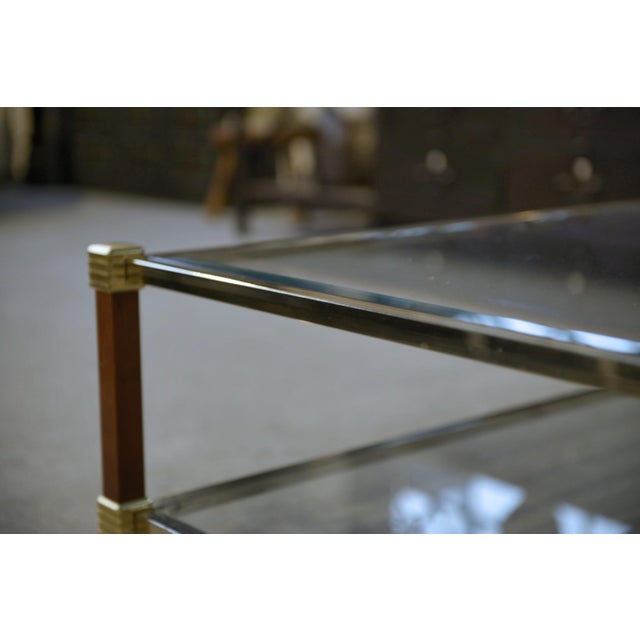 A gilded brass frame accented with slender stretchers, varnished wood-clad uprights, and fluted rings typical of the...