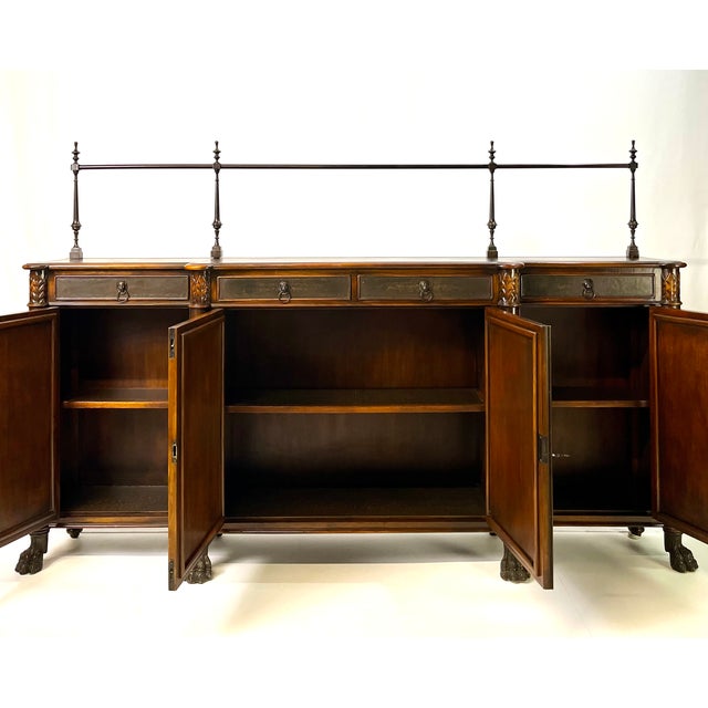 An exceptionally grand and narrow-profile Regency Revival sideboard attributed to Theodore Alexander. This masterfully...