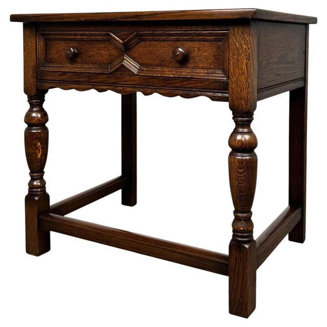 A handsome and well-crafted early 20th-century English side table in the Jacobean style, constructed in oak and...