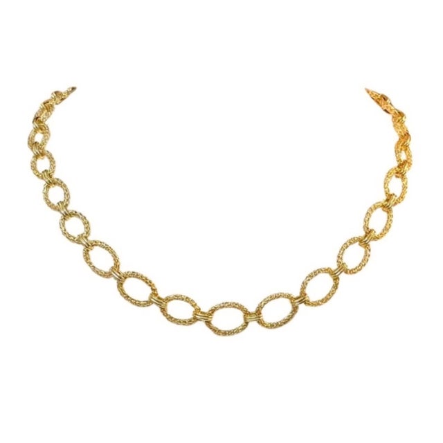 Mid-20th Century 14K Yellow Gold Oval Link Necklace. Necklace features a continuous series of textured oval links, each...