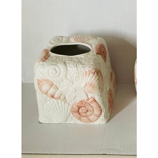 Vintage ceramic tissue box cover decorated with sea shell decor.