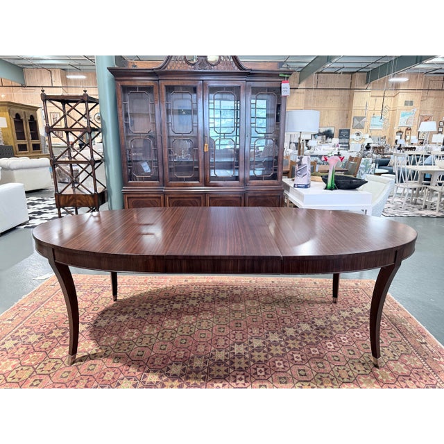 A sophisticated Ethan Allen Hathaway dining table showcasing rich zebrawood veneer paired with Indonesian mahogany solids...