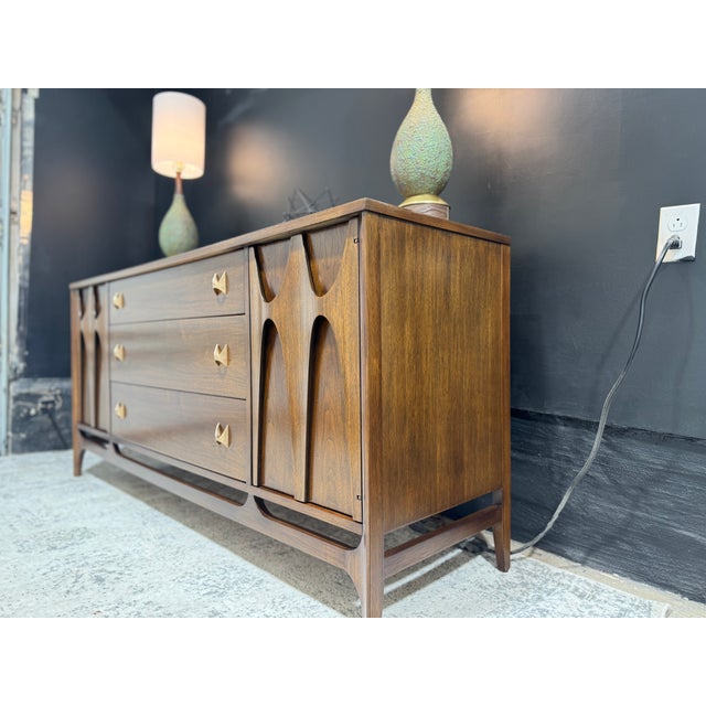 An iconic example of American mid-century modern design, this stunning 66-inch Broyhill Brasilia credenza has been...