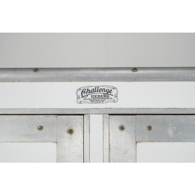 Non mechanical refrigerator that relied entirely on heavy blocks of harvested ice to preserve food. Made by the Challenge...
